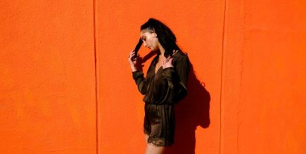 Depop image, woman with orange background